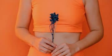 woman holding blue petaled flower