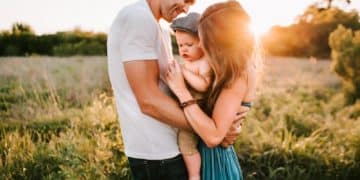 family photo on green grass during golden hour