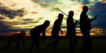 silhouette photo of group people standing on grass
