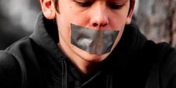 man in black hoodie wearing silver framed eyeglasses