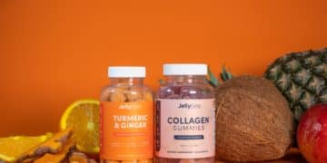 3 glass bottles on brown wooden table